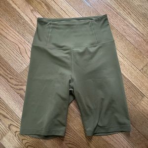 Girlfriend collective bike shorts in brown-green color, size small